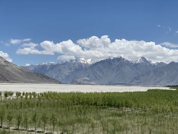 Scenic view of lake and mountains against sky