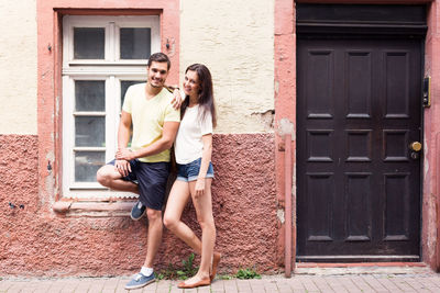 Portrait of young couple standing outdoors