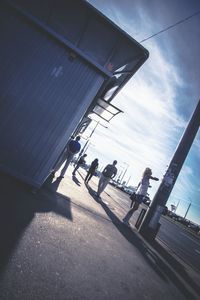 Low angle view of people walking on road