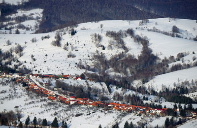 High angle view of houses amidst snow covered mountains