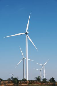 Wind turbines on beautiful sunny summer autumn mountain landsape.