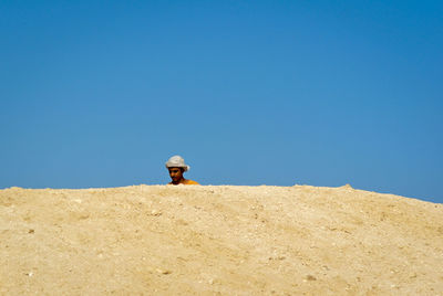 Low angle view of man against clear sky