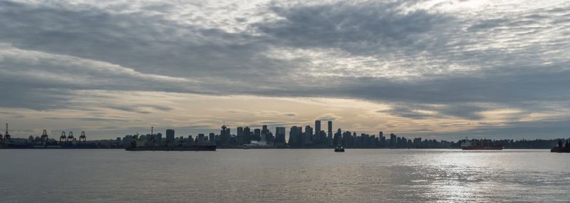 Panoramic view of sea and buildings against sky