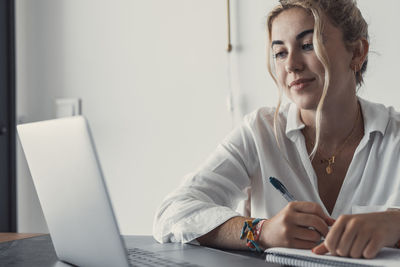 Young woman using laptop at home