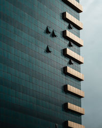 A close up shot of a urban building with a few windows open