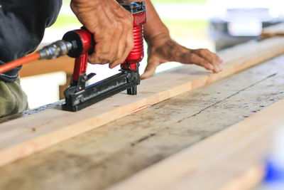 Cropped hand working on wood