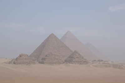 View of egyptian pyramids in light haze