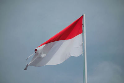 Low angle view of flag against sky