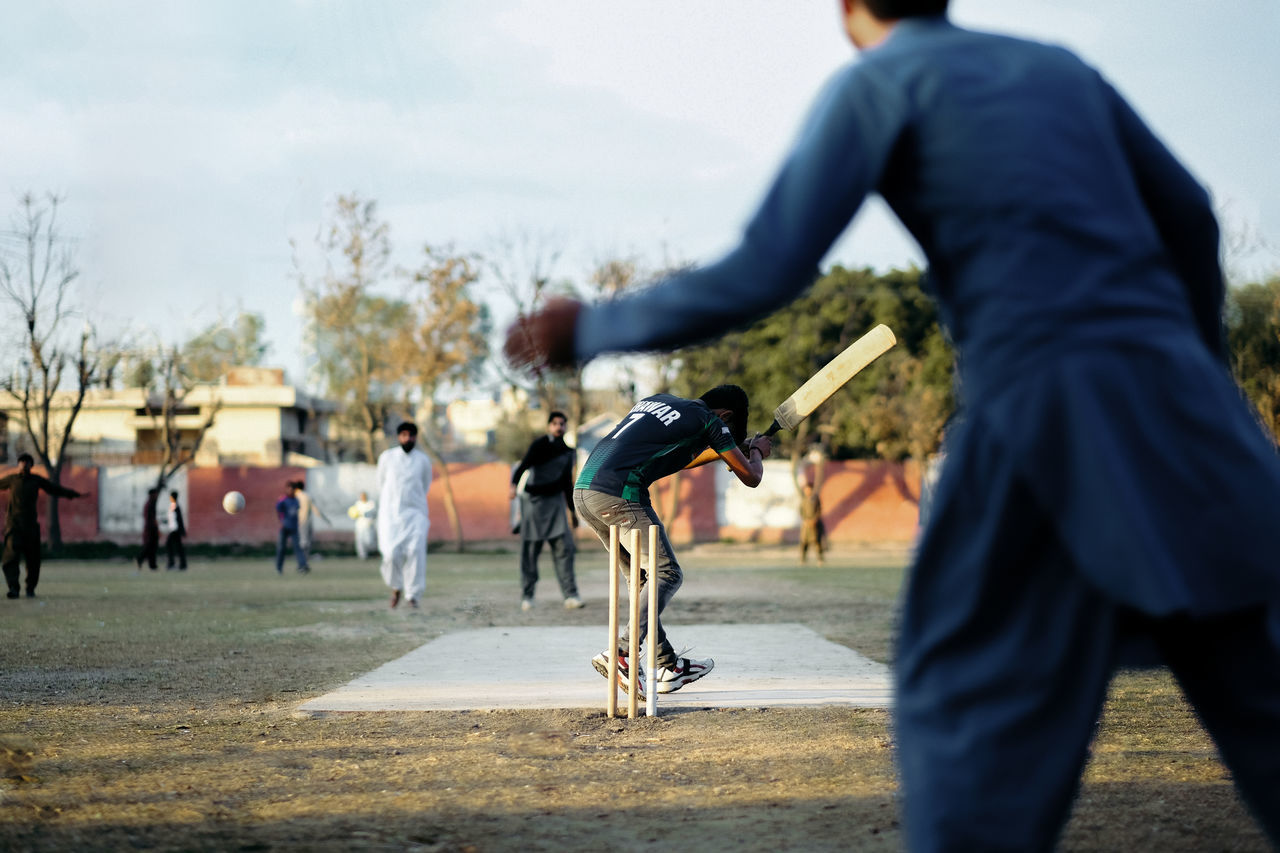 REAR VIEW OF MAN SKATEBOARDING