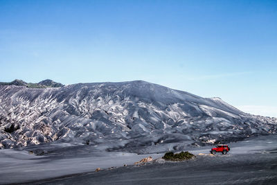 Scenic view of snowcapped mountains against clear blue sky