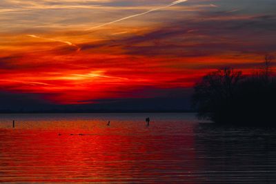 Scenic view of sea against orange sky