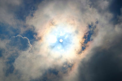 Low angle view of moon in cloudy sky