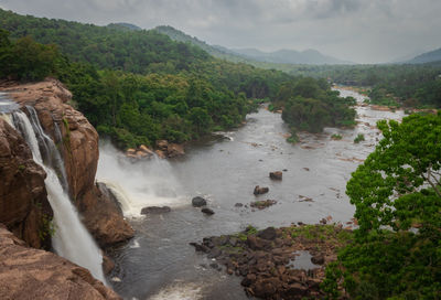 Athirapally waterfall with cloudy sky and green forests of the western ghat range