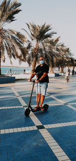 Man riding e-scooter  on street in city