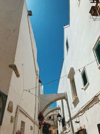 Low angle view of buildings against blue sky