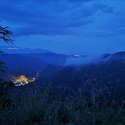 Scenic view of mountains against blue sky at dusk