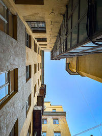 Low angle view of buildings against clear blue sky