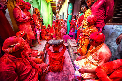 Devotees throw colour powder at each other as they celebrate during the lathmar holi festival. 