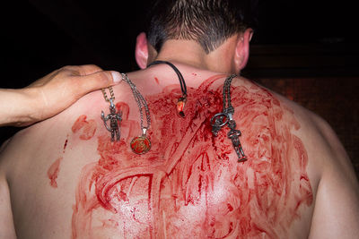 Close-up of shirtless man with blood
