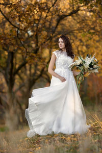 Low section of woman standing on field