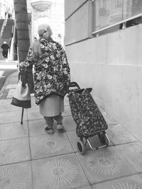 Full length of woman standing by railing