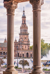 Historic building seen through columns against sky