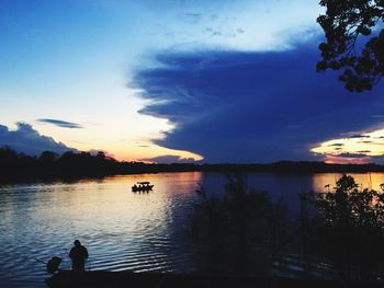 Scenic view of calm lake at sunset