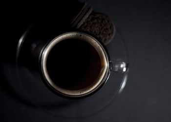 Directly above shot of coffee cup against black background