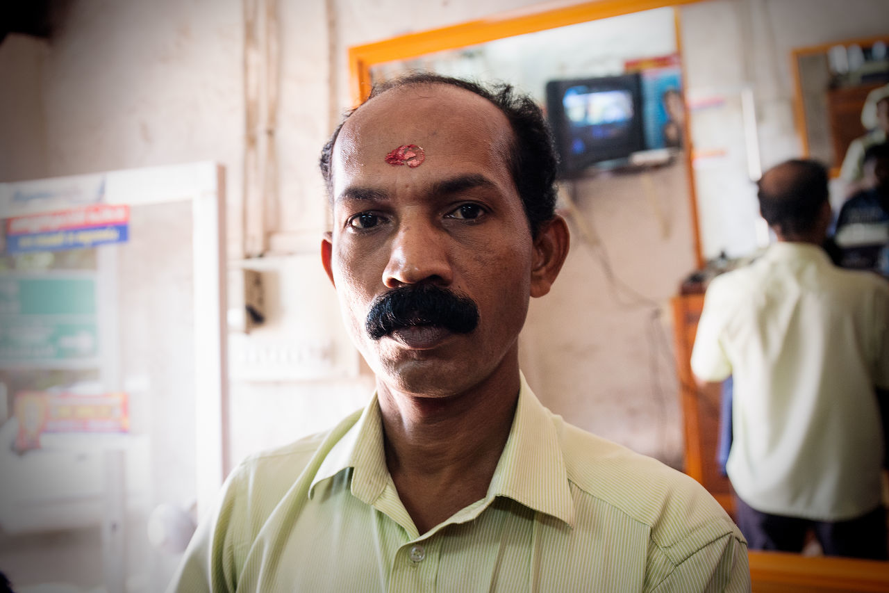 CLOSE-UP PORTRAIT OF MAN AT HOME