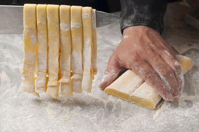 Cropped hands of chef preparing food on table in commercial kitchen