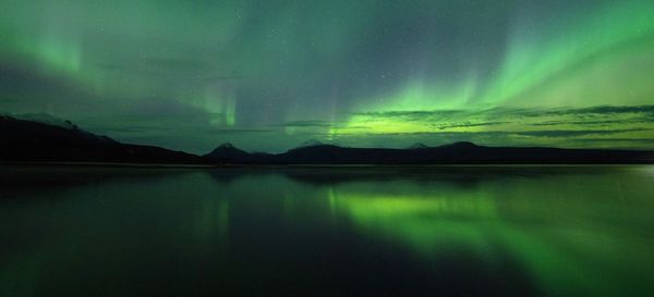 Scenic view of lake against sky at night