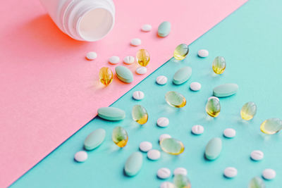 High angle view of pills spilling from bottle