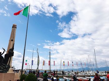 Low angle view of flags against sky