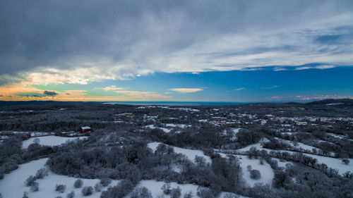 Snow covered landscape against sky