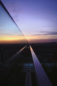 Modern cityscape against sky during sunset