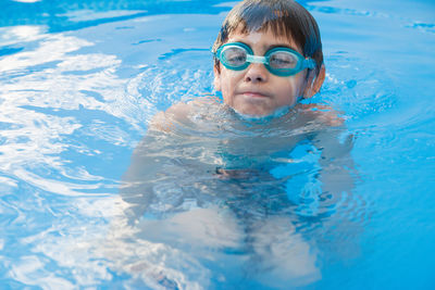 Boy swimming in pool