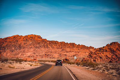 Road amidst rocks against sky