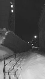 Illuminated road at night during winter