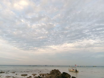 Scenic view of sea against cloudy sky