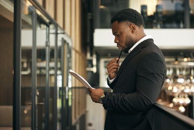 Portrait of businessman using mobile phone