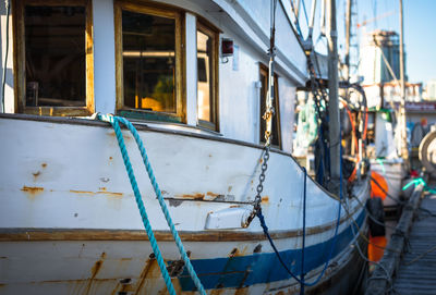 Close-up of sailboats moored at harbor