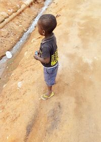 Rear view of boy walking in water