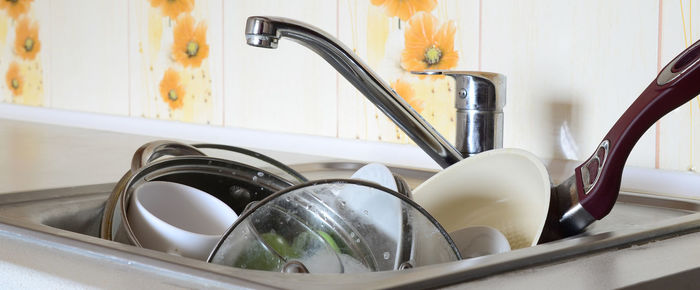 Faucet over utensils in sink