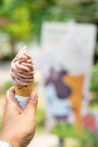 Close-up of hand holding ice cream cone