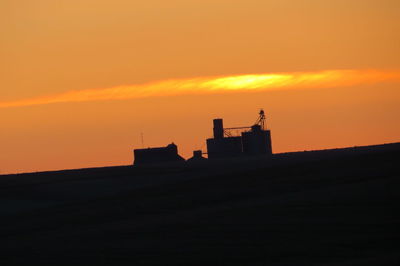 Silhouette of built structure at sunset