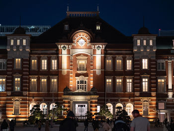 Group of people in front of building at night