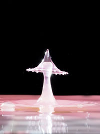 Close-up of water splashing over black background