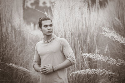 Portrait of young man standing on field