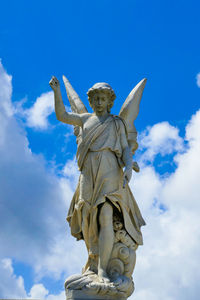 Low angle view of statue against blue sky