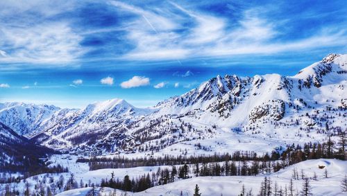 Scenic view of snowcapped mountains against sky